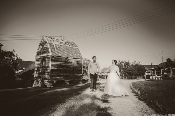 Bride and groom walking through Huntstile Organic Farm