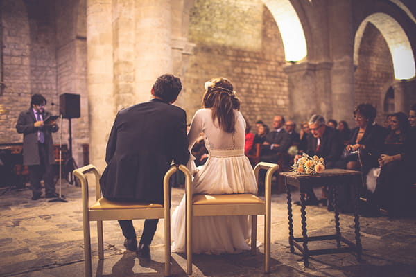 Bride and groom sitting in church of intimate wedding ceremony