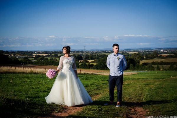 Bride and groom in field at Huntstile Organic Farm