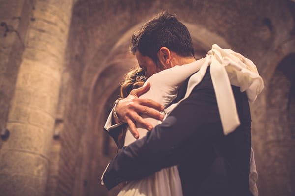 Bride and groom hug