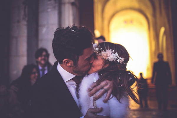 Bride and groom kiss outside wedding ceremony