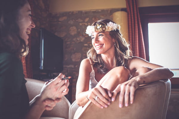 Bride sitting in chair smiling