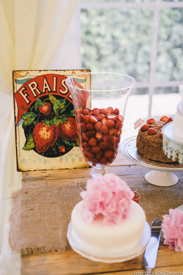 Strawberries in vase and rustic sign