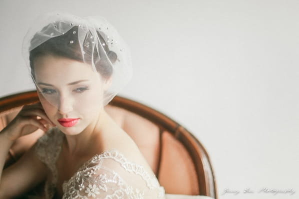 Bride with veil sitting in chair