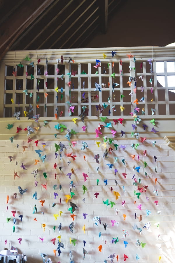 Wall of coloured paper cranes