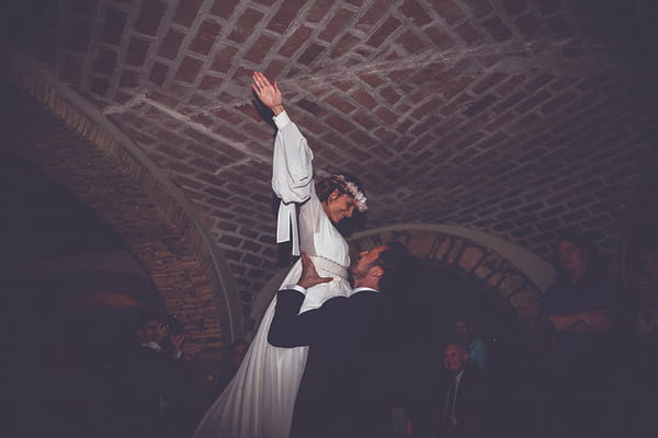 Groom lifting bride up