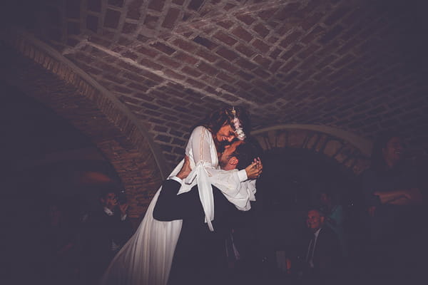 Bride and groom hug on dance floor