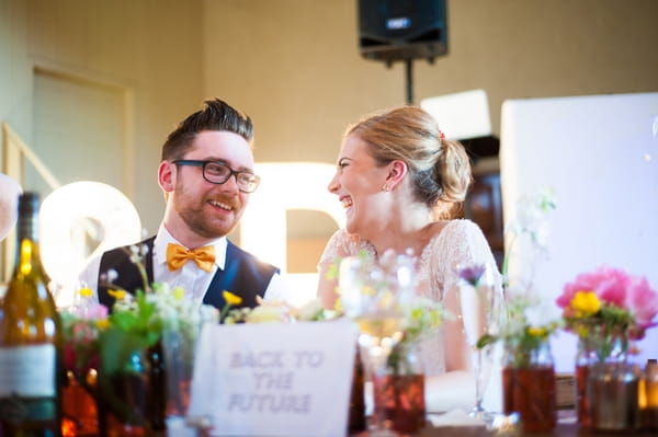 Bride and groom sitting at table