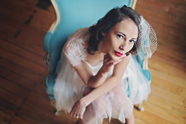 Bride leaning forward on chair