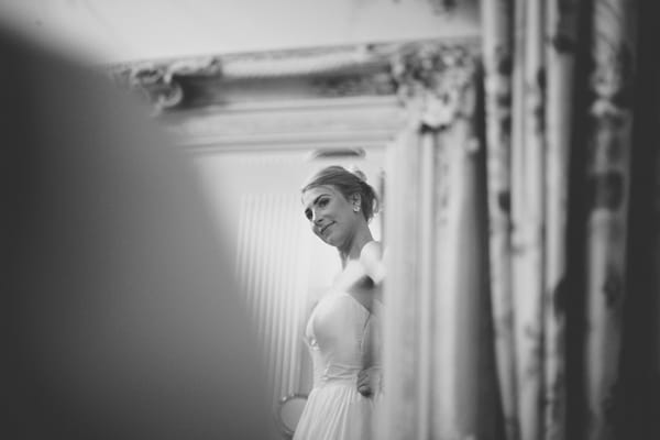 Bride looking in mirror