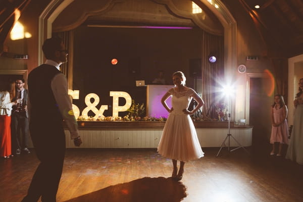 Bride with hands on hips on dance floor