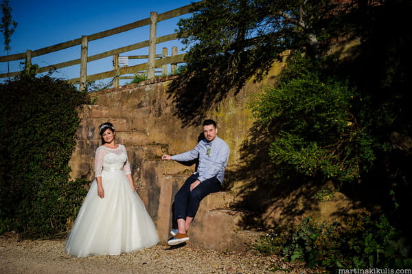 Bride and groom sitting on steps at Huntstile Organic Farm