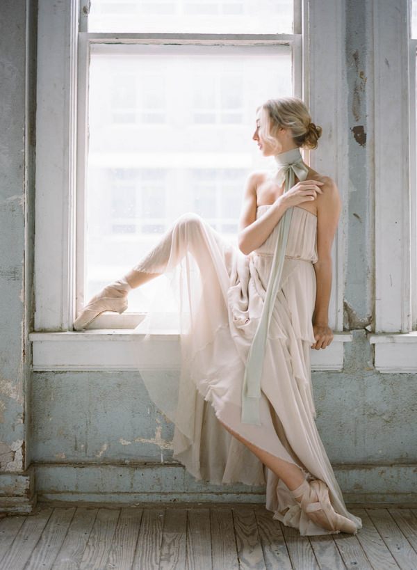 Ballerina bride sitting on window ledge