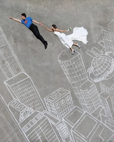 Bride with groom as Superman on chalk city skyline - Picture by Gardner Hamilton