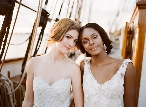 Two brides touching heads