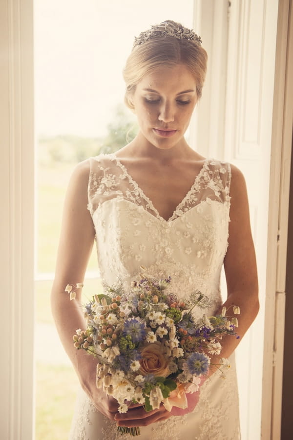 Bride looking down at bouquet