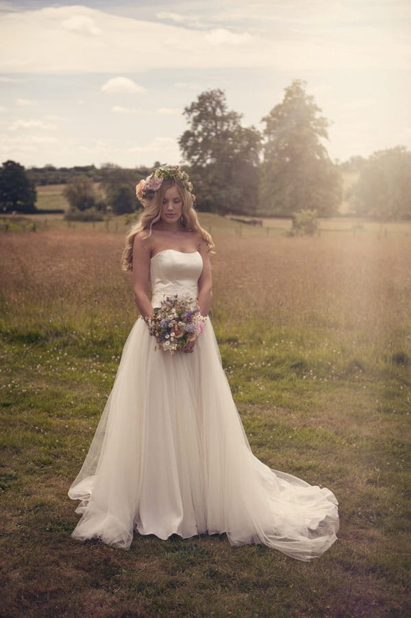 Bride with flower crown holding rustic bouquet