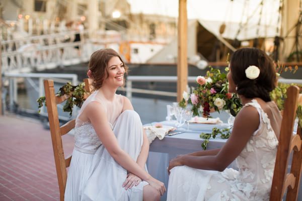 Two brides sitting at table