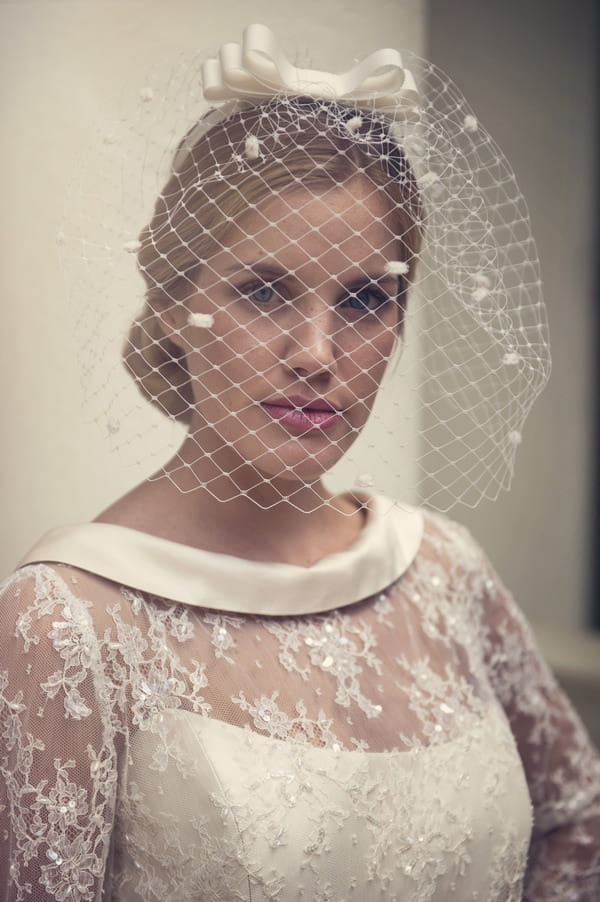 Bride with birdcage veil and lace detail dress