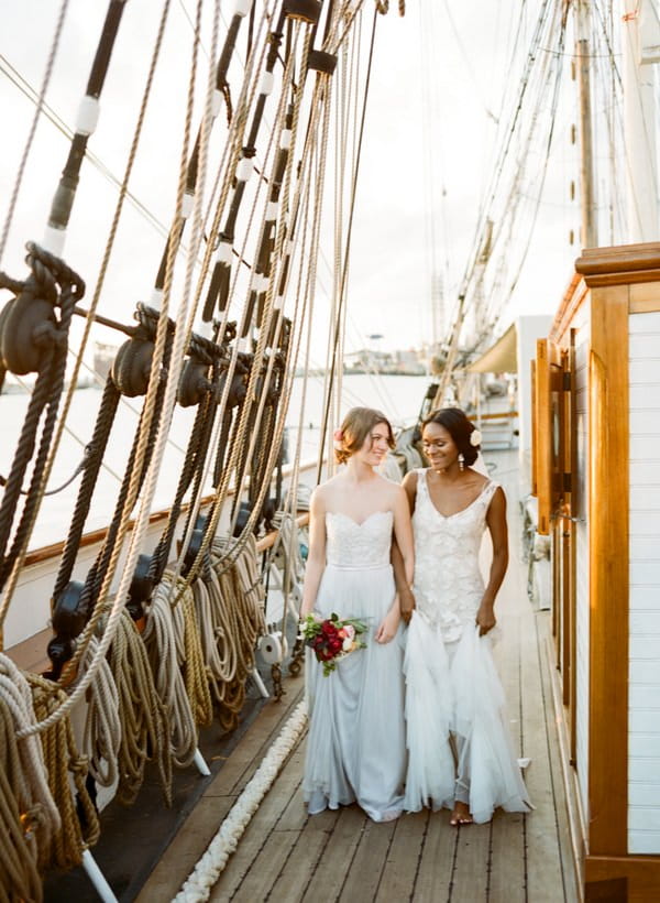 Bride and groom walking on deck of the Tall Ship Elissa