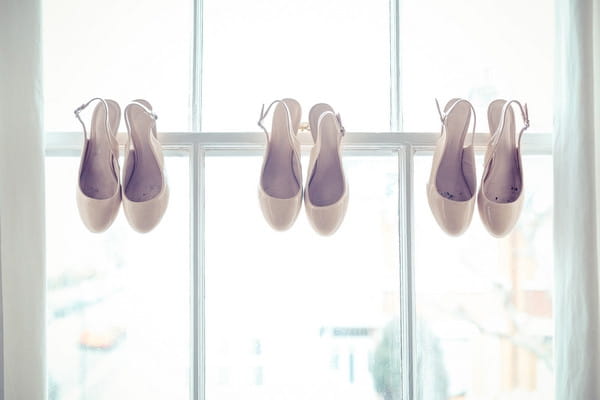 Wedding shoes hanging in window