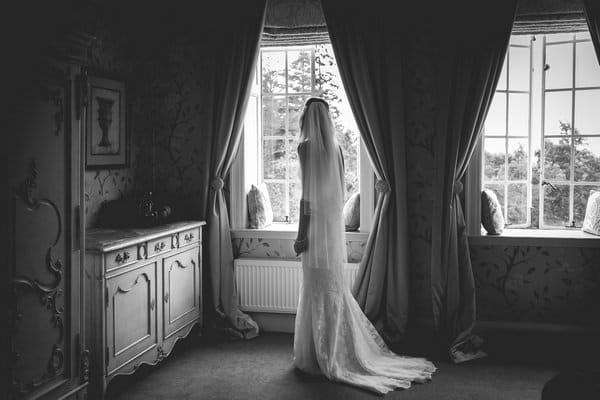 Bride standing by window - Picture by Andrew Keher Photography