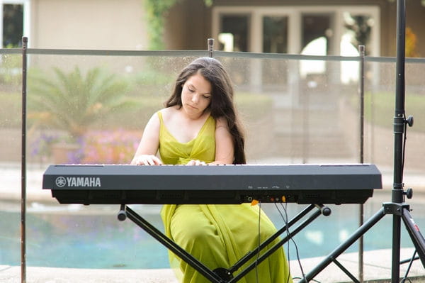 Young bridesmaid playing keyboard