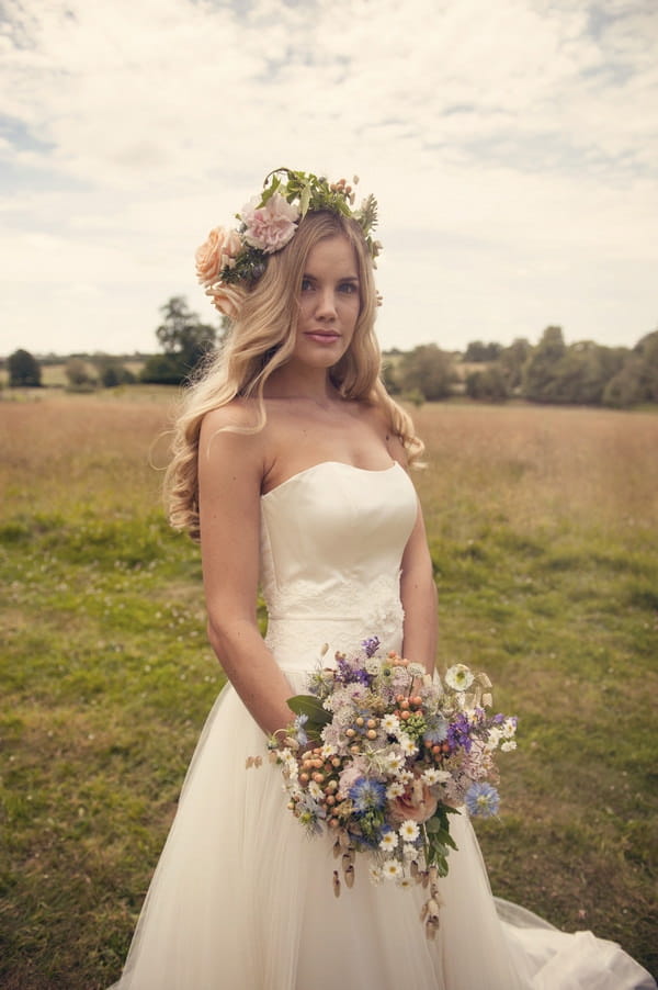 Bride with flower crown holding rustic bouquet