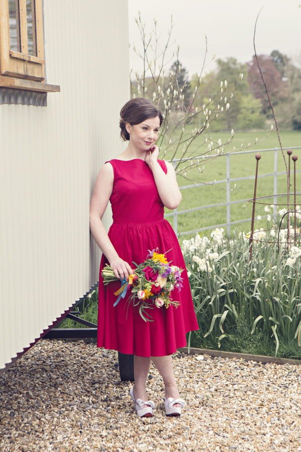 Bride in red vintage wedding dress holding bouquet