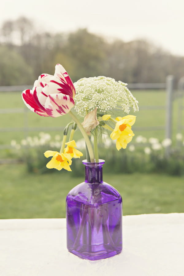 Wedding flowers in purple glass vase