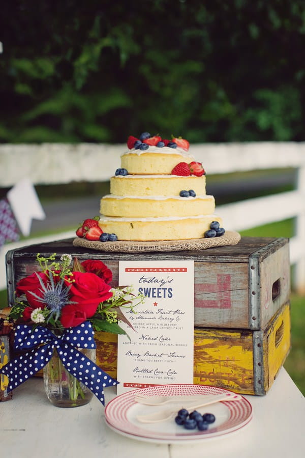 Naked wedding cake displayed on crates