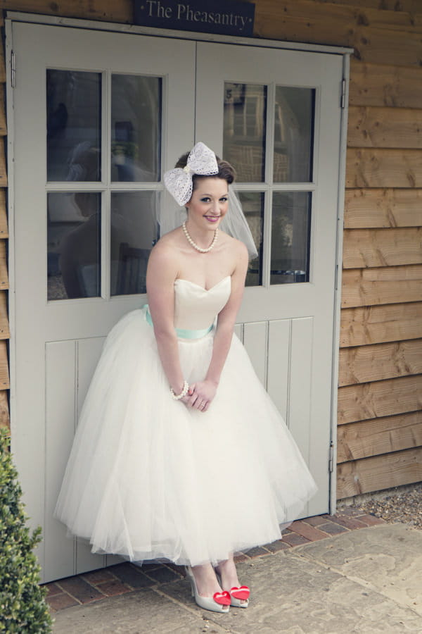 Bride wearing white wedding dress and large bow in hair