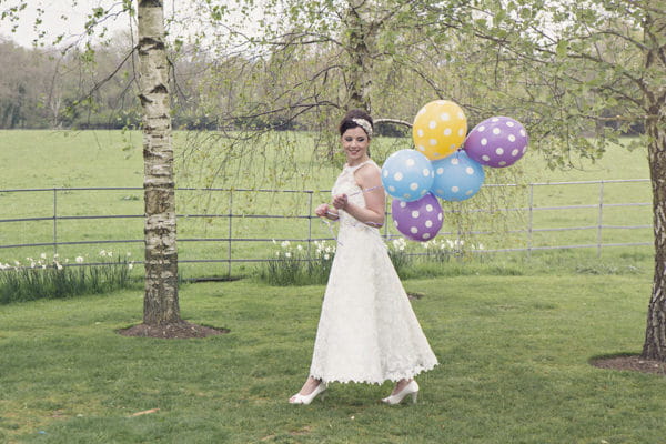 Bride holding spotty balloons