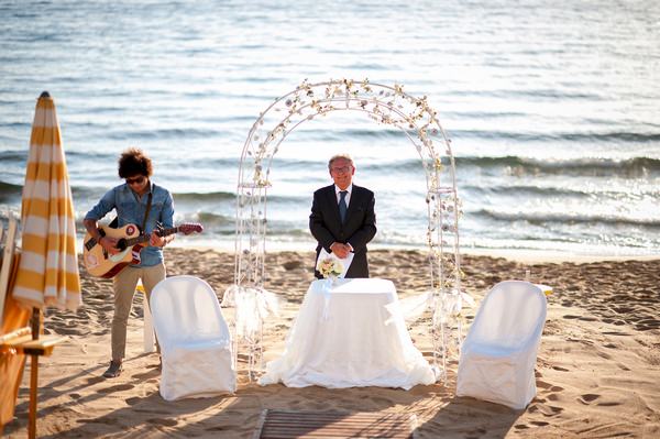 Wedding ceremony arch on beach in Italy