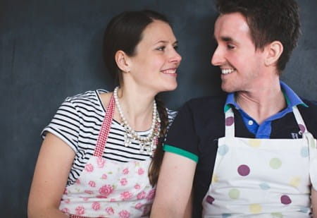 Couple wearing baking aprons