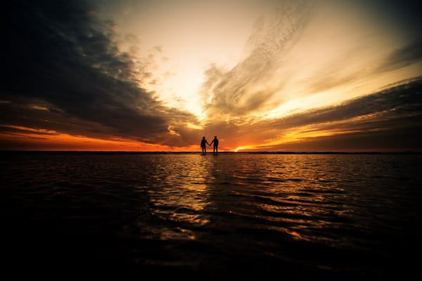 Silhouette of couple appearing to stand on water - Picture by Andrew Keher Photography