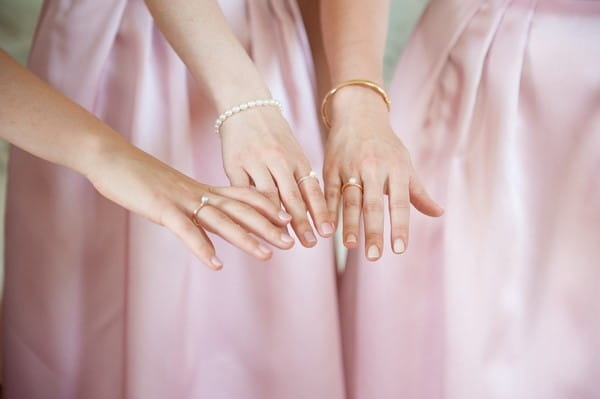 Bridesmaids showing rings on hands