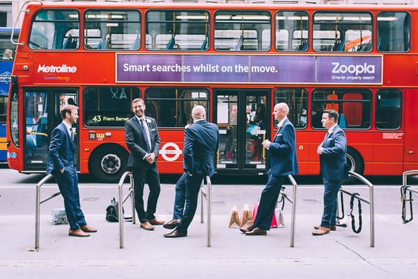 Groomsmen in London with bus going past