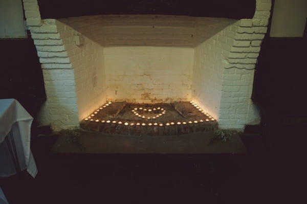 Shape of heart in candles in fireplace