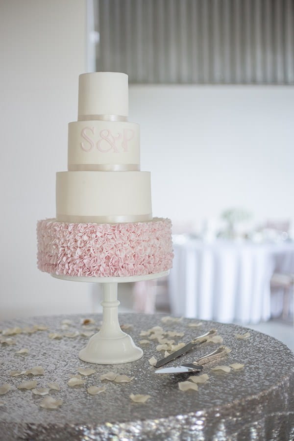 Wedding cake with pink ruffled bottom tier
