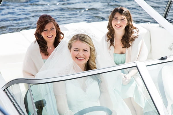 Bride and bridesmaids on speed boat