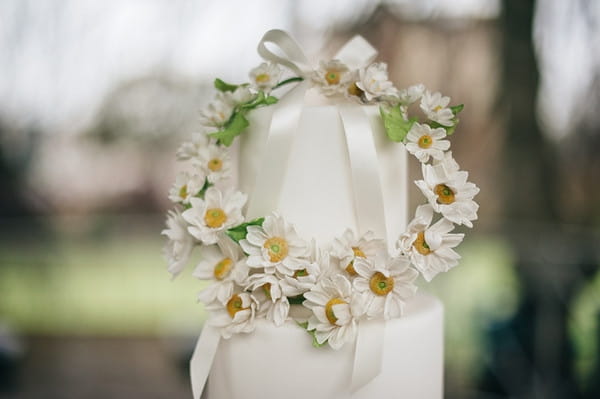 Flower chain on top of wedding cake