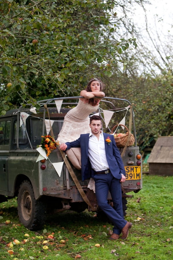 Bride and groom on back of Land Rover at Deer Park