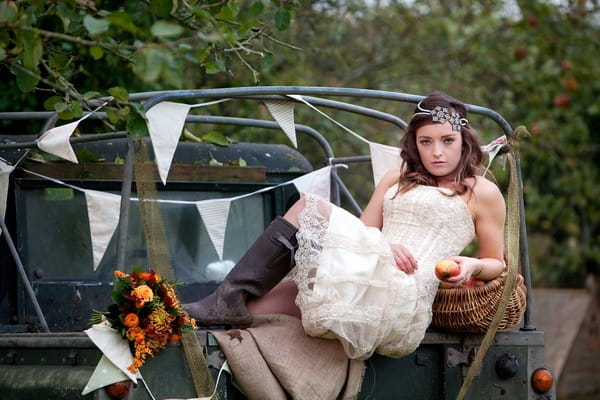 Bride laying across back of Land Rover