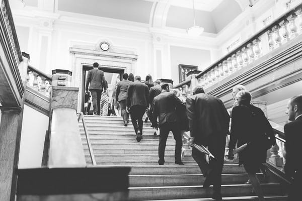 Wedding guests walking up steps of Islington Town Hall