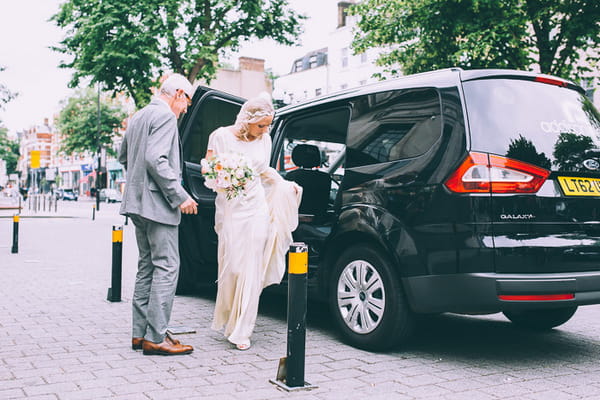 Bride getting out of black cab