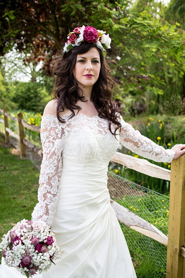 Bride in vintage wedding dress with lace sleeves