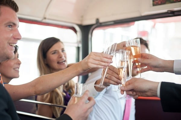 Toast with champagne on wedding bus