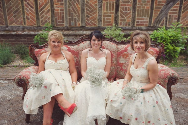Bride and bridesmaids sitting on couch