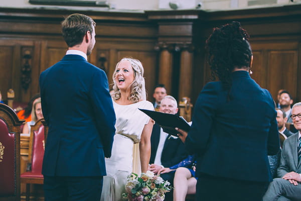 Bride laughing during wedding ceremony at Islington Town Hall